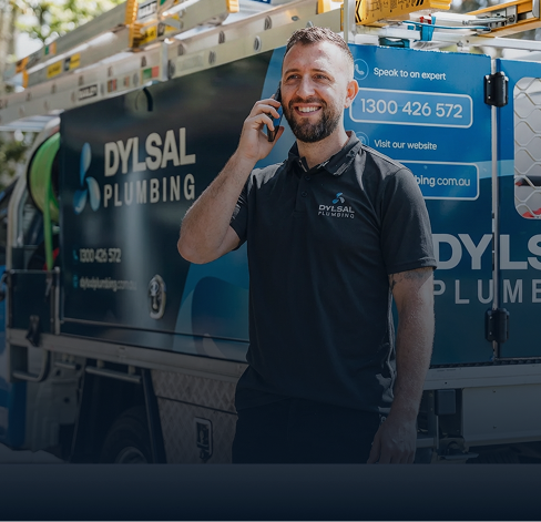 DYLSAL plumber on a phone call guiding a customer through emergency damage prevention